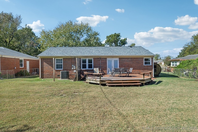 back of property featuring central air condition unit, a deck, and a lawn