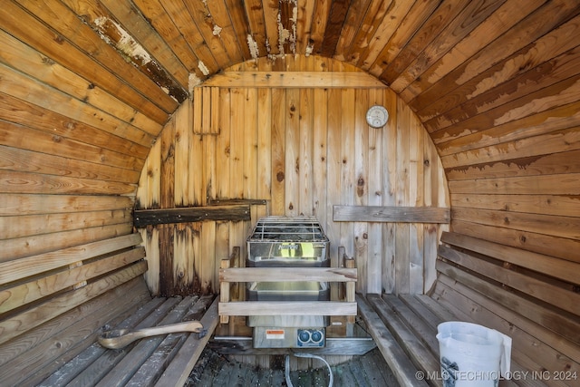 view of sauna featuring wooden walls and wooden ceiling