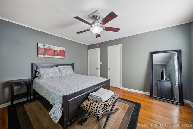 bedroom featuring ornamental molding, wood-type flooring, and ceiling fan