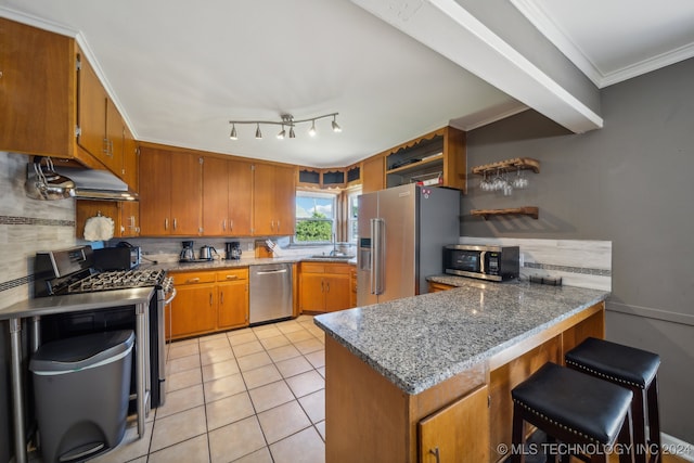 kitchen featuring light tile patterned floors, appliances with stainless steel finishes, kitchen peninsula, ornamental molding, and a breakfast bar