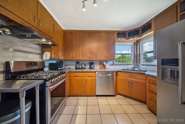 kitchen featuring sink, appliances with stainless steel finishes, decorative backsplash, and light tile patterned floors