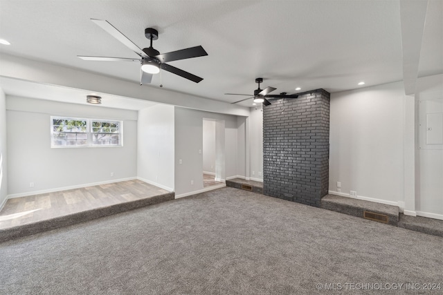 unfurnished living room with ceiling fan and carpet flooring