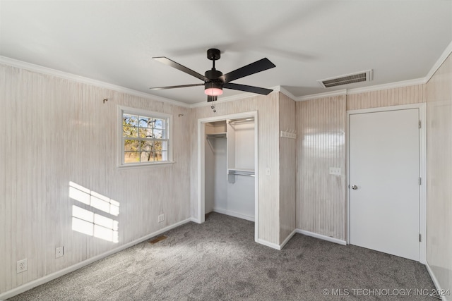 unfurnished bedroom featuring crown molding, carpet flooring, and a closet