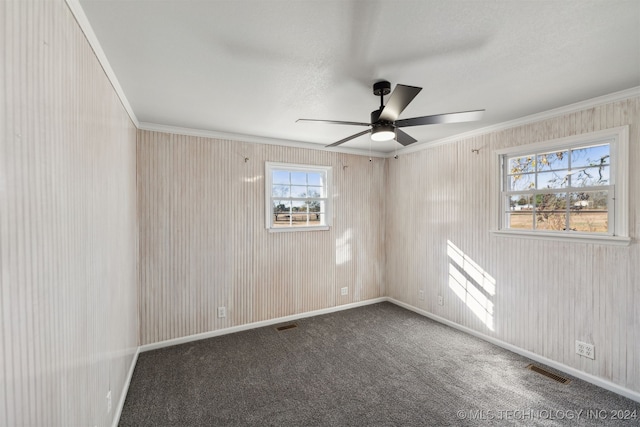 spare room with crown molding, carpet, and ceiling fan