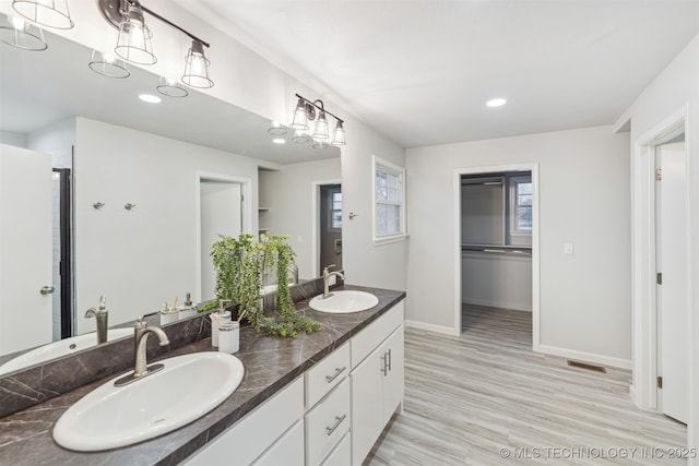 bathroom with vanity and hardwood / wood-style floors