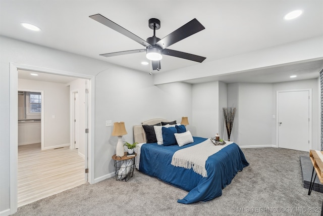 bedroom with ceiling fan and light carpet