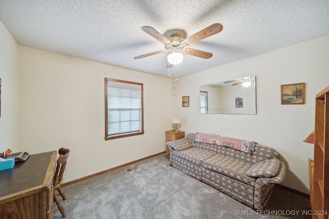 carpeted living room featuring a textured ceiling and ceiling fan