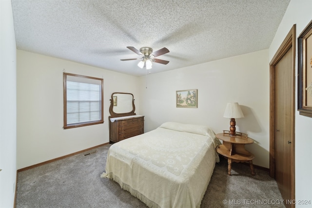 carpeted bedroom featuring a closet, a textured ceiling, and ceiling fan