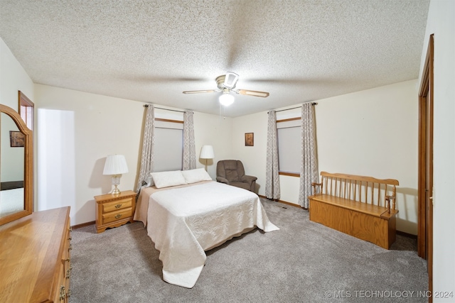 bedroom featuring a textured ceiling, carpet, and ceiling fan