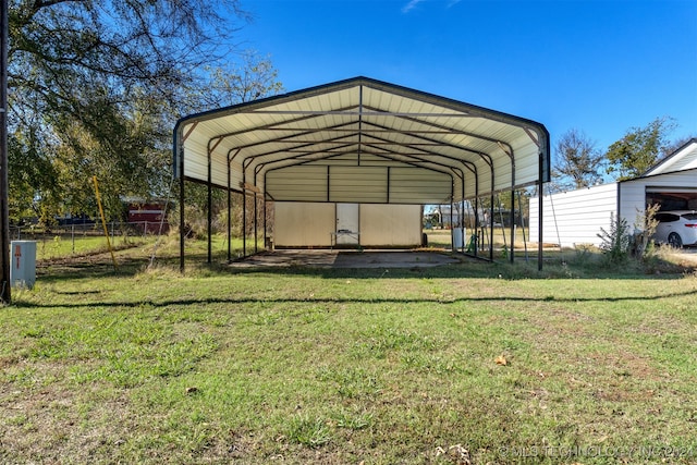 view of outdoor structure with a carport and a yard