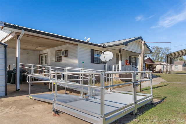 161 N Hickory, Tushka, OK 74525 - view of front facade with an AC wall unit and covered porch