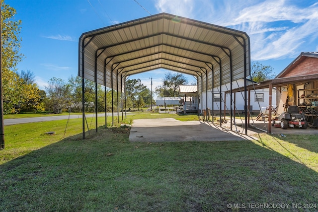 view of vehicle parking with a carport and a yard