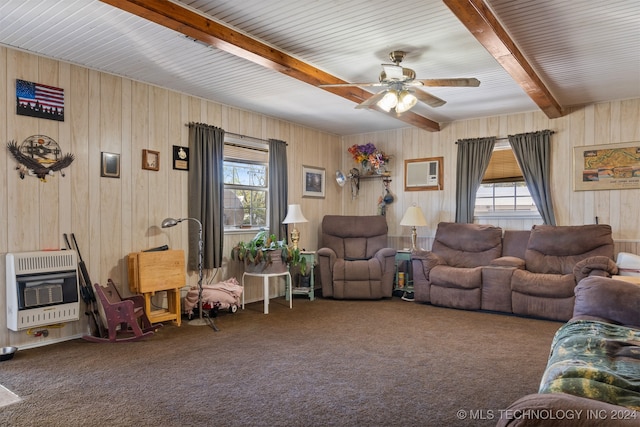 carpeted living room featuring ceiling fan, beam ceiling, a wealth of natural light, and heating unit