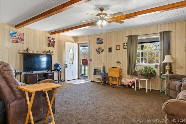 carpeted living room with beam ceiling, a wealth of natural light, wooden walls, and ceiling fan