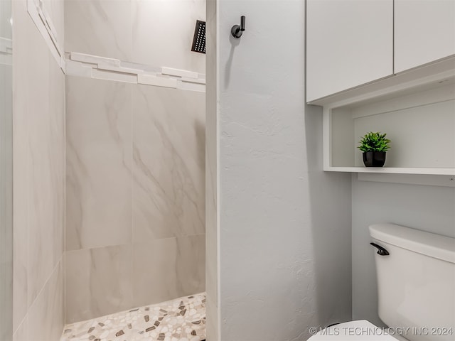 bathroom featuring toilet and a shower