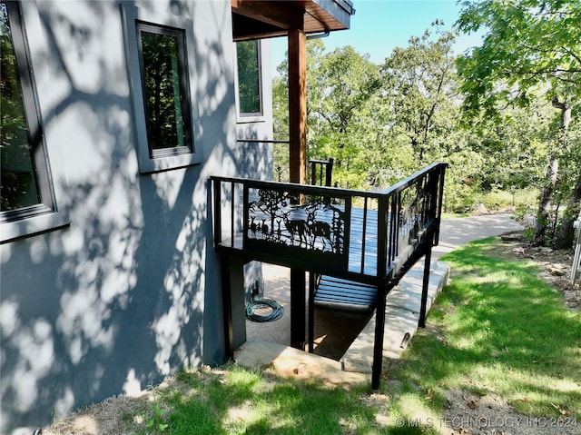 view of property exterior with a deck