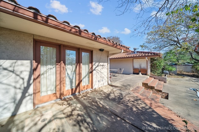 view of side of home with a patio area