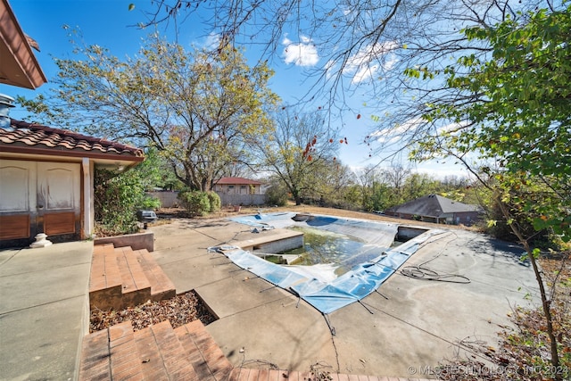 view of swimming pool with a patio