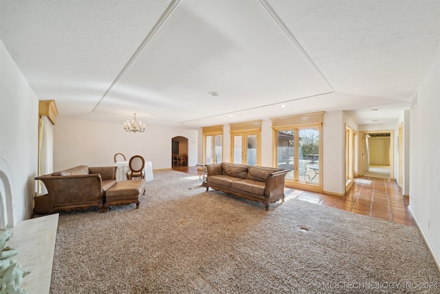 living room featuring light carpet and a notable chandelier