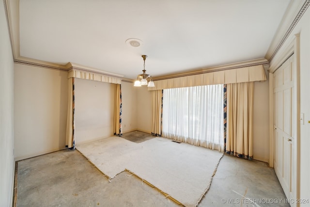 interior space with ornamental molding and a chandelier