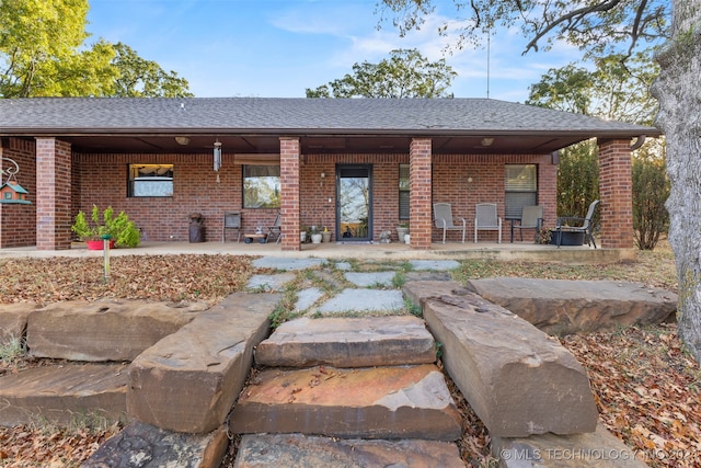 back of house with a patio