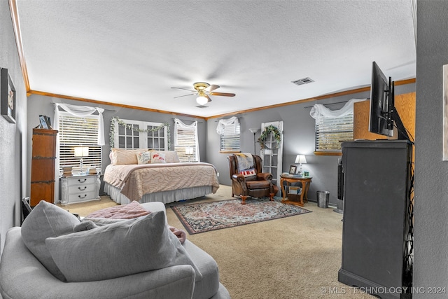 carpeted bedroom featuring ornamental molding, a textured ceiling, and ceiling fan