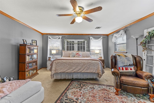 carpeted bedroom featuring ornamental molding, a textured ceiling, and ceiling fan