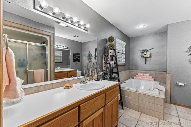 bathroom featuring vanity, independent shower and bath, and tile patterned flooring