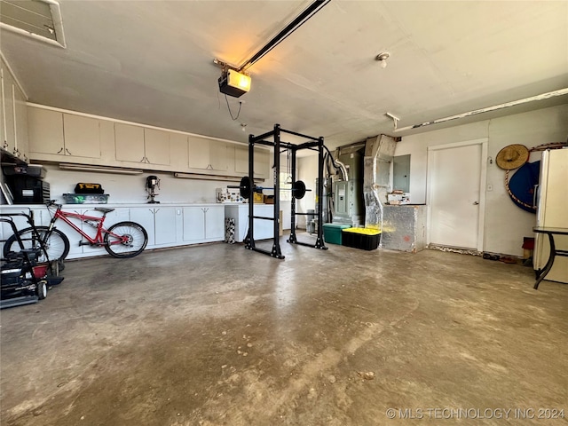 garage with heating unit, a garage door opener, washer / dryer, and electric panel