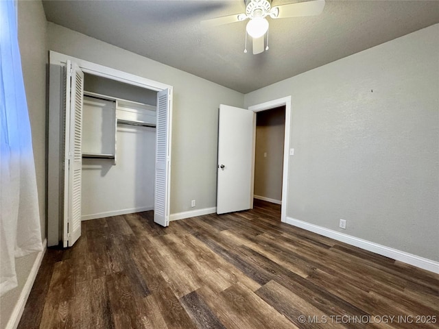 unfurnished bedroom featuring ceiling fan, dark hardwood / wood-style floors, a closet, and a textured ceiling