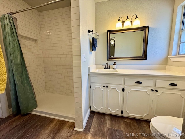 bathroom with a shower with curtain, vanity, toilet, and wood-type flooring