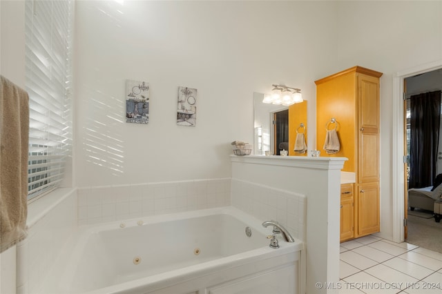 bathroom with tile patterned flooring and a tub to relax in