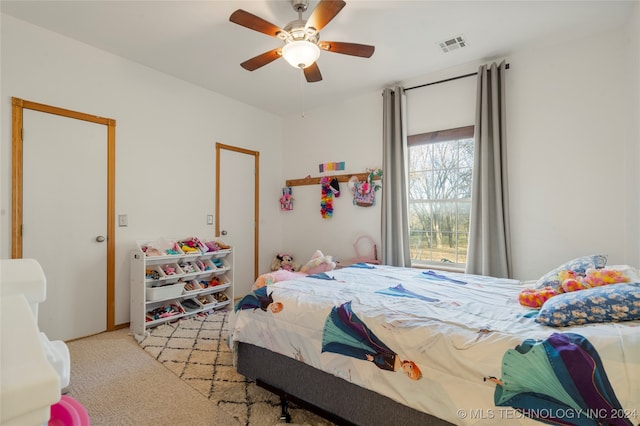 bedroom featuring light colored carpet and ceiling fan