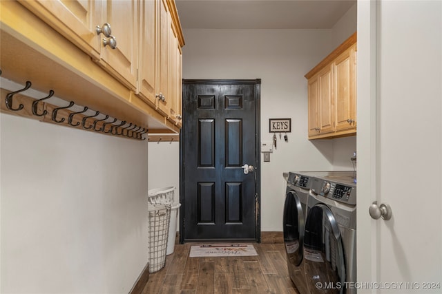 laundry area featuring cabinets, independent washer and dryer, and dark hardwood / wood-style floors