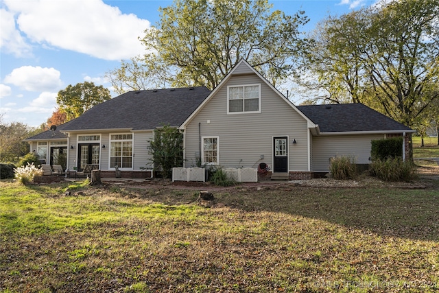 back of property featuring a lawn