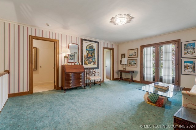 sitting room featuring french doors, carpet floors, and ornamental molding