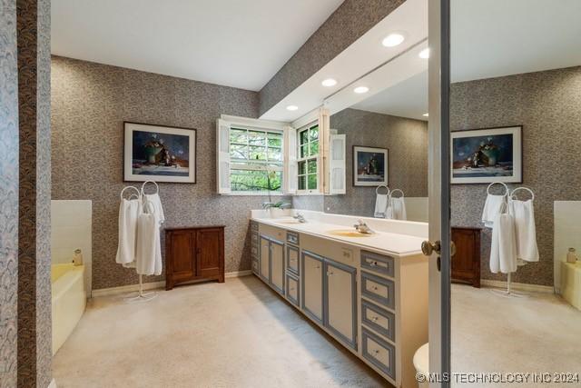 2840 S Victor Ave, Tulsa, OK 74114 - full bath with a garden tub, double vanity, wallpapered walls, and recessed lighting