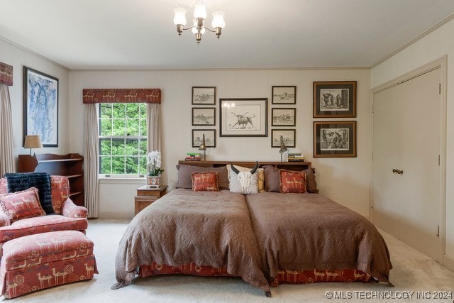 carpeted bedroom featuring a notable chandelier and ornamental molding