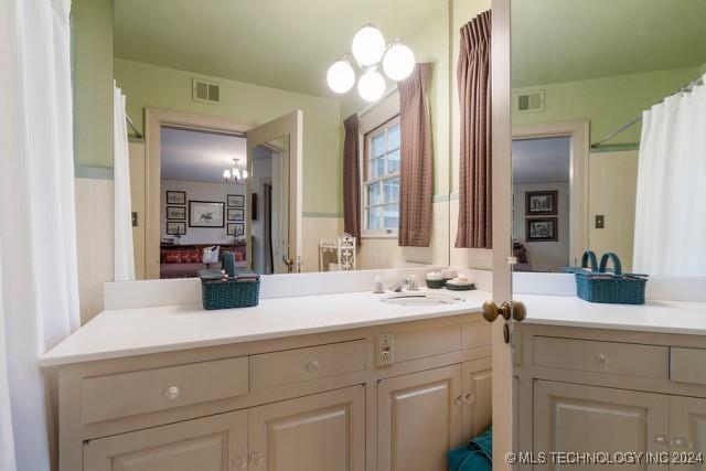 2840 S Victor Ave, Tulsa, OK 74114 - bathroom with vanity, a chandelier, and a shower with curtain