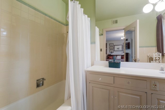 bathroom with shower / bath combo and vanity