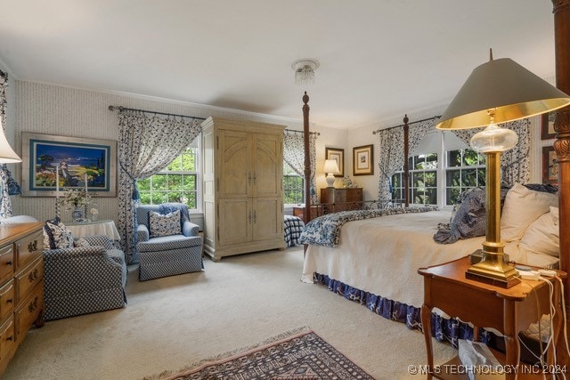 carpeted bedroom with ornamental molding