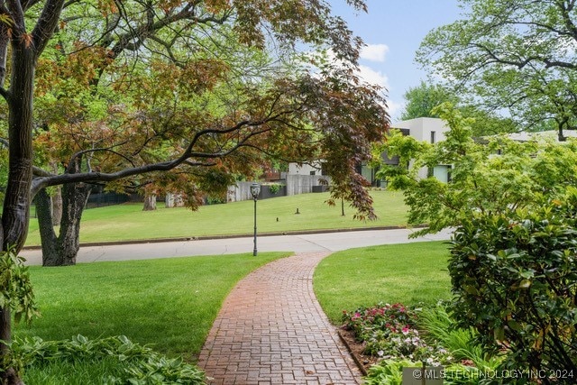 view of property's community with a lawn