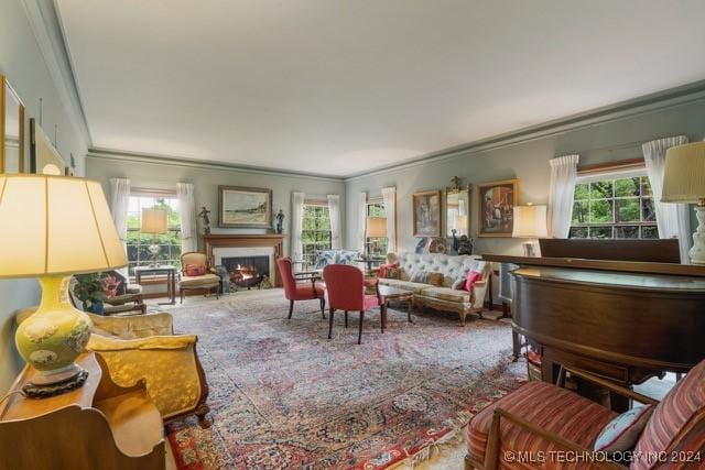 2840 S Victor Ave, Tulsa, OK 74114 - living room with crown molding, a lit fireplace, and carpet flooring