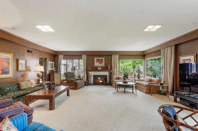 2840 S Victor Ave, Tulsa, OK 74114 - carpeted living area featuring wood walls and a lit fireplace