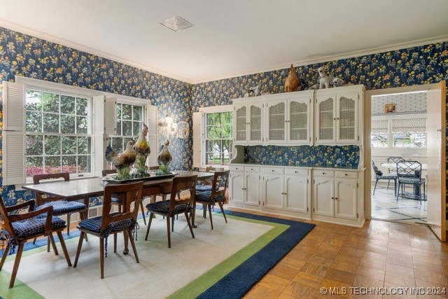 dining area with light parquet floors and crown molding