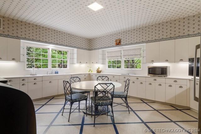 2840 S Victor Ave, Tulsa, OK 74114 - dining space featuring plenty of natural light and inlaid floor details