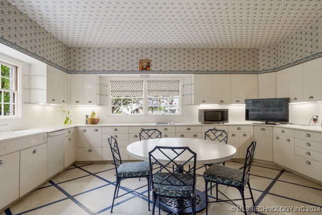 kitchen featuring white cabinets and dishwasher