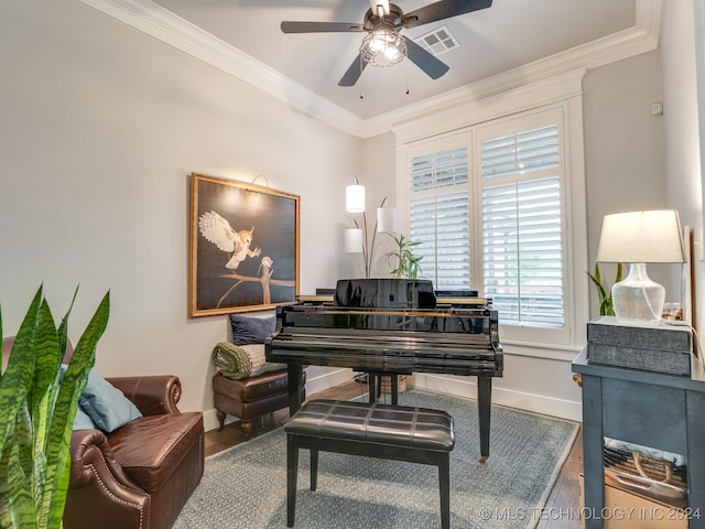 miscellaneous room featuring ceiling fan, wood-type flooring, and ornamental molding