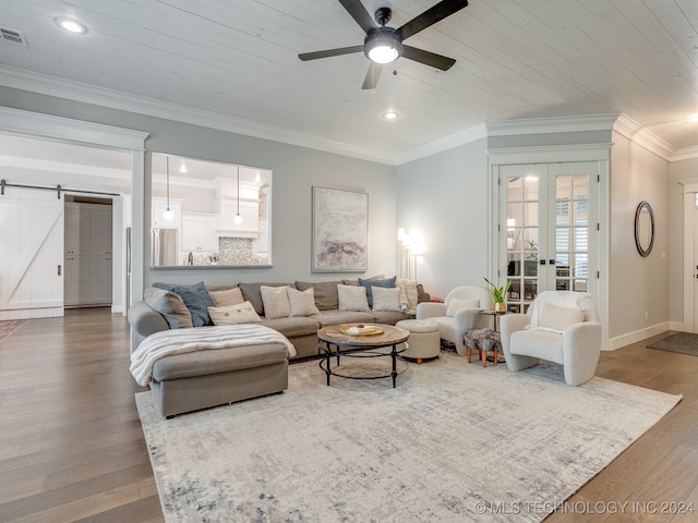 living room featuring crown molding, a barn door, hardwood / wood-style flooring, and wooden ceiling