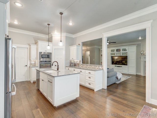 kitchen with white cabinetry, appliances with stainless steel finishes, wood-type flooring, and a center island with sink